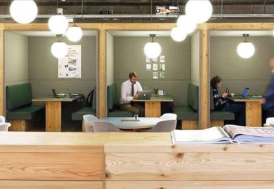 Modern communal area with private wooden seating booths and warm globe lighting.