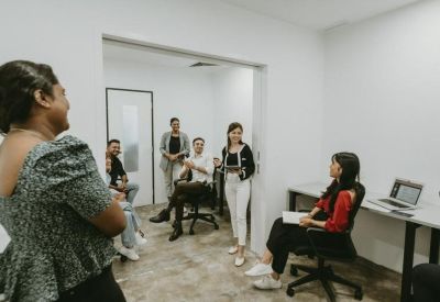 Collaborative meeting space with several people engaged in a discussion.