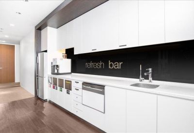 Modern white kitchen with a dark splashback and refresh bar text.
