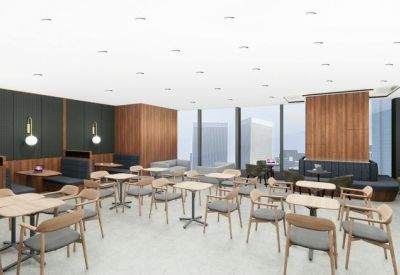 Bright coworking lounge with various seating arrangements, timber paneling, and floor-to-ceiling windows.