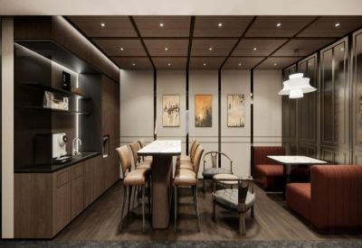 Cozy communal breakout area featuring a coffee bar, high-top table, and red booth seating.