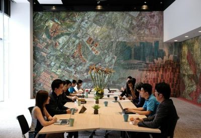 Meeting room with a long table and a large wall mural depicting a city map.