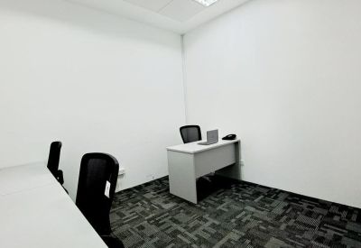 Private workspace with a minimalist grey desk and patterned carpet.