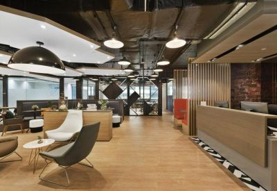 Modern reception lobby with a wooden front desk and stylish pendant lighting.