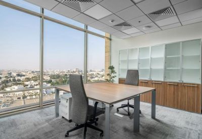 Private office with two desks, ergonomic chairs, and a large window showing an urban landscape.
