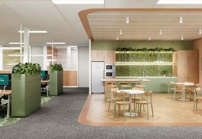Spacious communal breakout area with a modern kitchen, dining tables, and indoor plants.