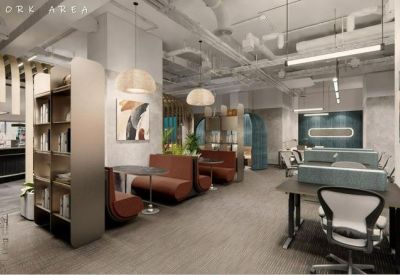 Co-work area with leather booths, bookshelves, and open-plan desks under industrial ceilings.