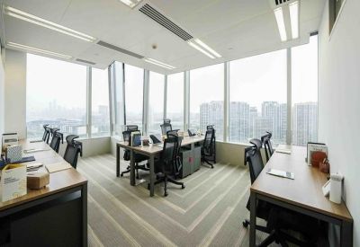 Private glass-walled office suite with multiple desks and floor-to-ceiling windows.
