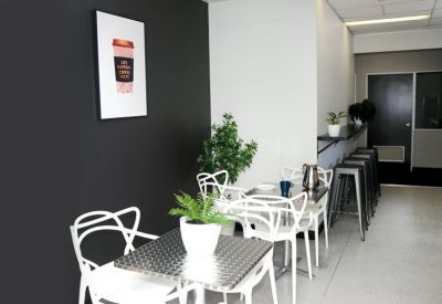 Café area featuring metal chairs and modern design elements.