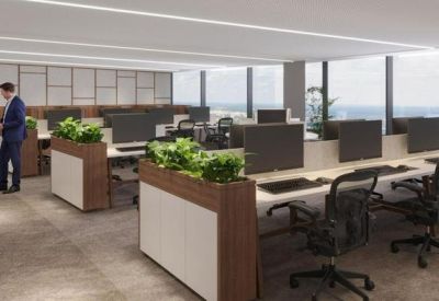 Modern open-plan workspace with wooden planters and city skyline views.