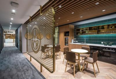 Communal kitchen and dining area with a decorative gold screen and wood slat ceiling.