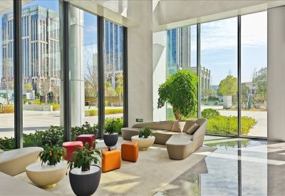 Spacious lobby with floor-to-ceiling windows and colorful designer seating.