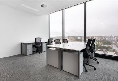 Private corner office suite with large windows and city views.