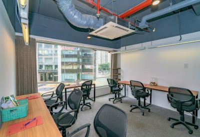 Private office space with wooden desks and city views through large windows.