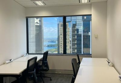 Three-person private office with large windows overlooking the city harbor.