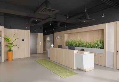 Minimalist reception area with a light wood desk and a feature wall of indoor plants.