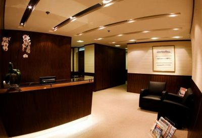 Professional reception area with dark wood paneling and a modern front desk.