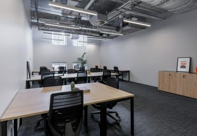 Dedicated office suite with six workstations and a wooden storage cabinet.