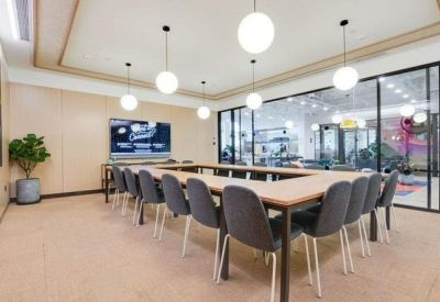 Large meeting room with a U-shaped table and glass partitions.