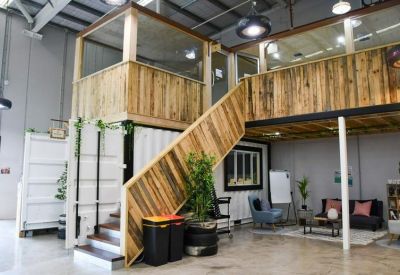 Spacious communal area with a timber mezzanine, stairs, and comfortable seating.