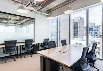 Shared workspace at 30 Prinsep Street, Singapore with desks and city skyline views.
