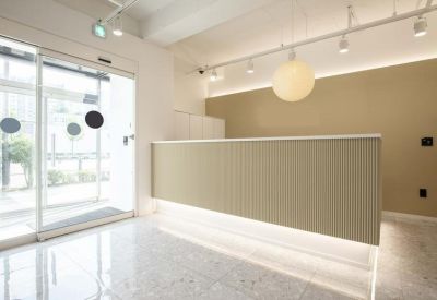 Bright reception desk with warm backlighting and a minimalist white aesthetic.