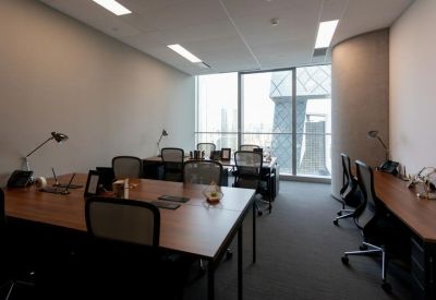 Professional multi-desk workspace with a large window showing a view of the CCTV building.