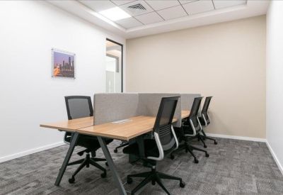 Shared workspace with four workstations separated by low privacy partitions.