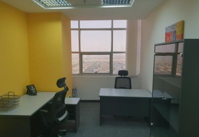 Private office featuring a yellow accent wall and city views through a large window.