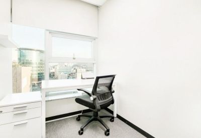 Minimalist single-person private office suite with a white desk and storage cabinet.