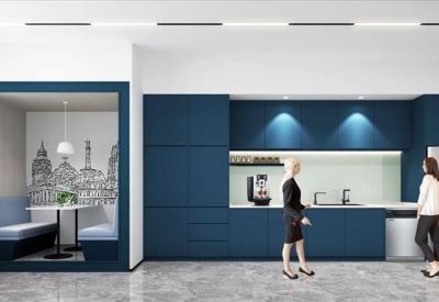 Communal kitchen and breakout area with blue cabinetry and booth seating.