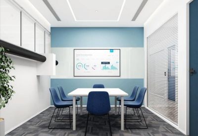 Meeting room with blue chairs and a digital presentation board.