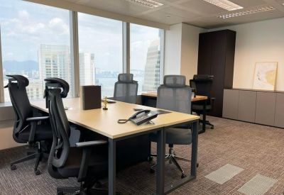 Modern private office suite with four desks and ergonomic chairs.