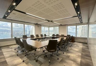 Large boardroom featuring a hollow square table and panoramic city views.