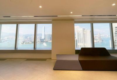 Modern lounge area with modular seating and floor-to-ceiling windows overlooking the harbor.