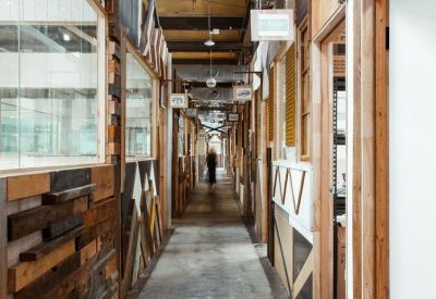 Long corridor with rustic wood-paneled walls and exposed ceiling beams.