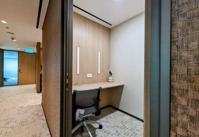 Private individual workspace booth with integrated lighting and wooden accents.