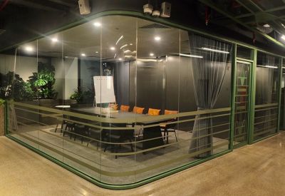 Spacious open-plan area with large table and indoor plants.
