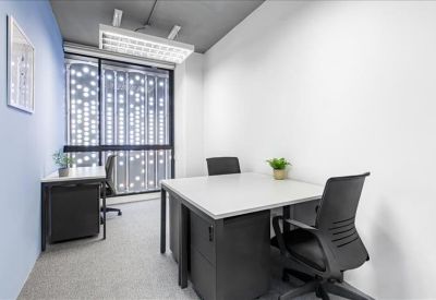 Private three-person office suite with white desks and patterned window film.