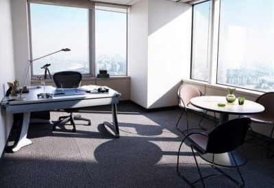 Private executive office with a glass desk, ergonomic chair, and floor-to-ceiling windows.