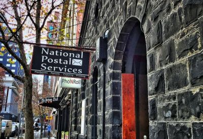 Exterior of the historic bluestone building at 585 Little Collins Street with arched doorways.