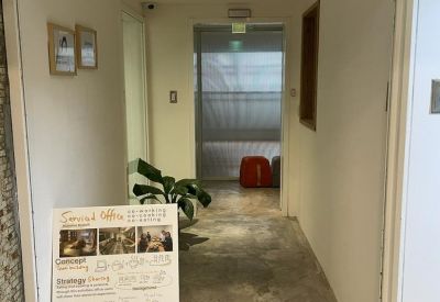 Entrance hallway with a white noren curtain and a detailed informational poster.
