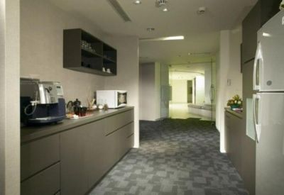 Communal kitchen area featuring a coffee machine, microwave, and refrigerator.