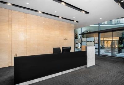 Modern meeting room featuring a wooden table and frosted glass wall.