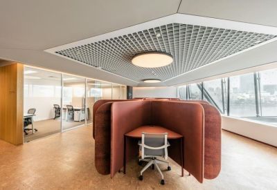 Private workstations with curved privacy screens and ergonomic seating.