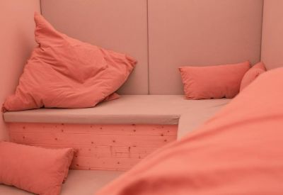 Cozy breakout nook featuring pink cushions and a built-in bench seat.