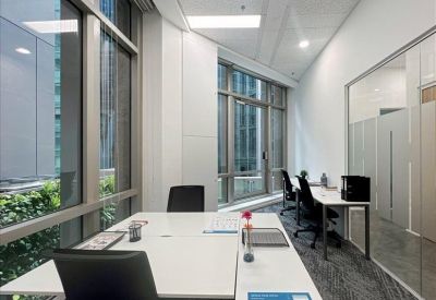Long view of a formal boardroom with integrated desk power and a wall-mounted television.