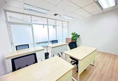 Internal office suite featuring light wood desks and frosted glass partitions.