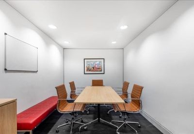 Meeting room with tan leather chairs and a red bench seat.