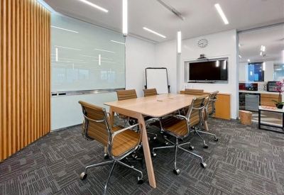 Sleek white reception desk set against a vertical timber-battened feature wall.